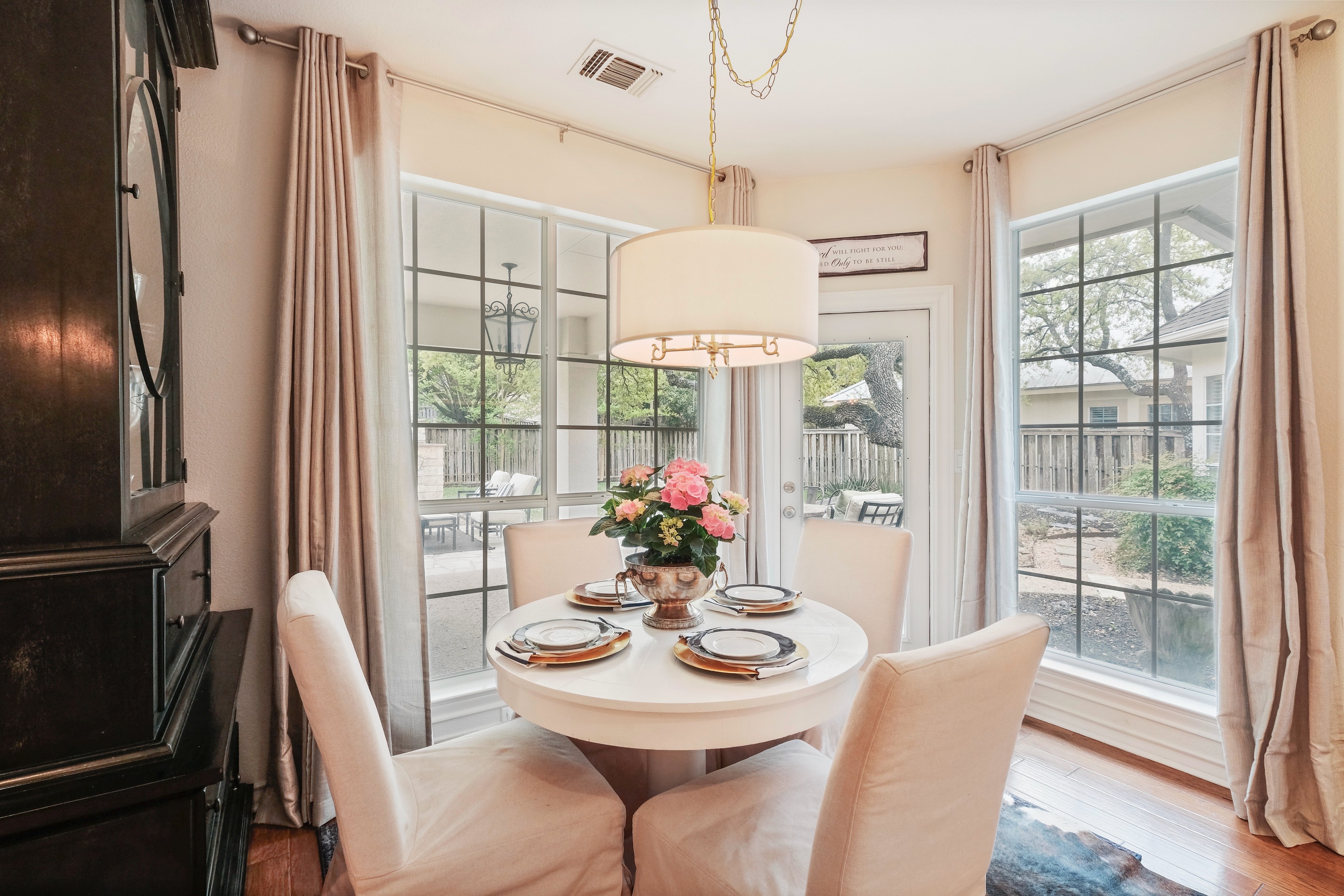 Breakfast nook after — styled dining set, drapery, and warm layered lighting